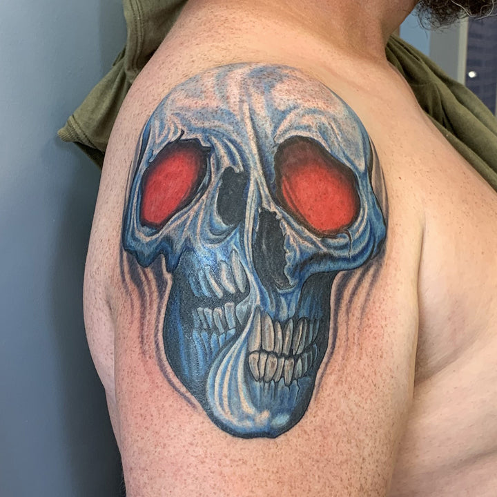 A blue skull with red eyes that is distorted in the middle.