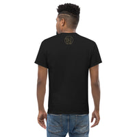 The rear view of an attractive man wearing a black t-shirt with a small gold Ink Union Clothing Co. logo positioned just below the collar.
