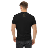 The rear view of an attractive man wearing a black t-shirt with a small ink union logo just below the neck line.