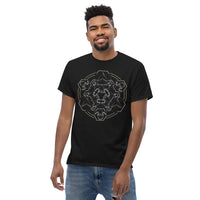 A man wearing a black t-shirt with a mandala built from white dot work skulls and gold and white geometric shapes.