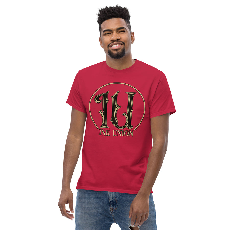 An attractive man wearing an Ink Union Clothing Co. cardinal red t-shirt featuring the Ink Union ring logo in black and gold.