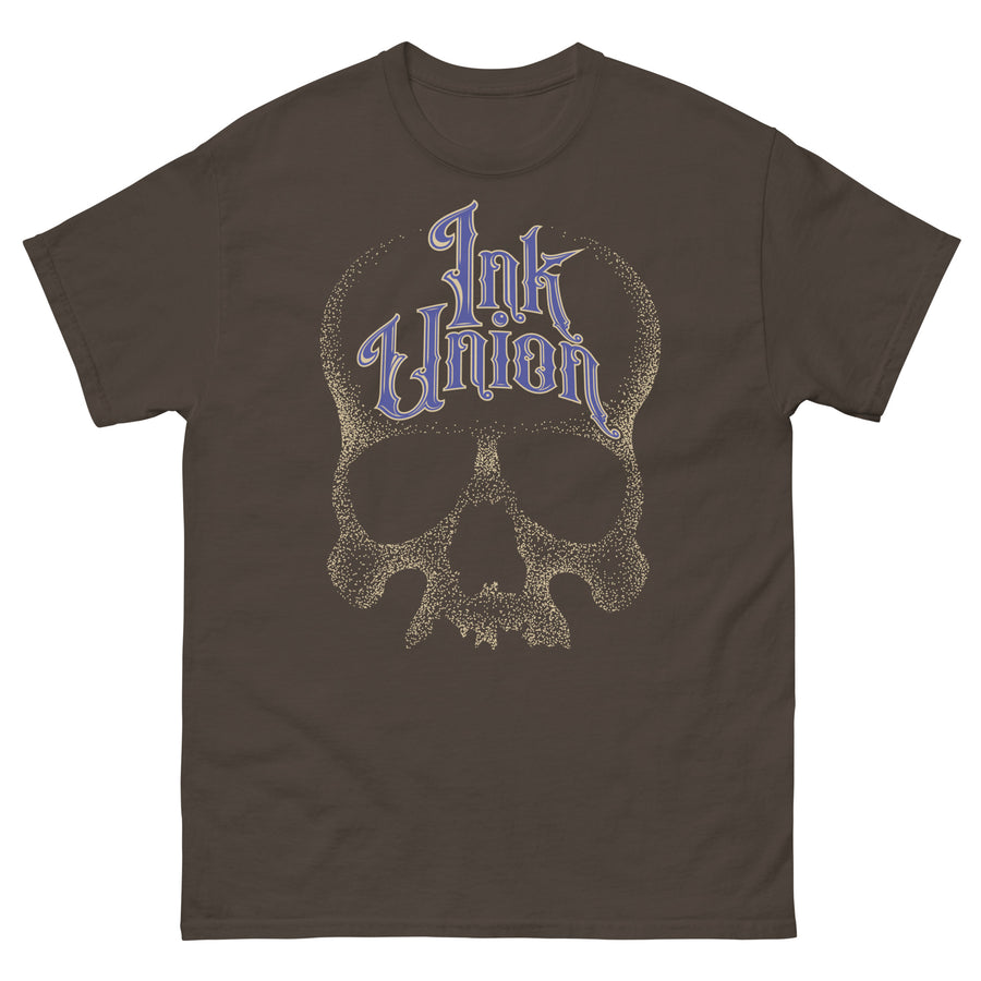 A chocolate brown t-shirt adorned with a gold dot work human skull  and the words Ink Union in fancy gold and blue lettering across the forehead of the skull.