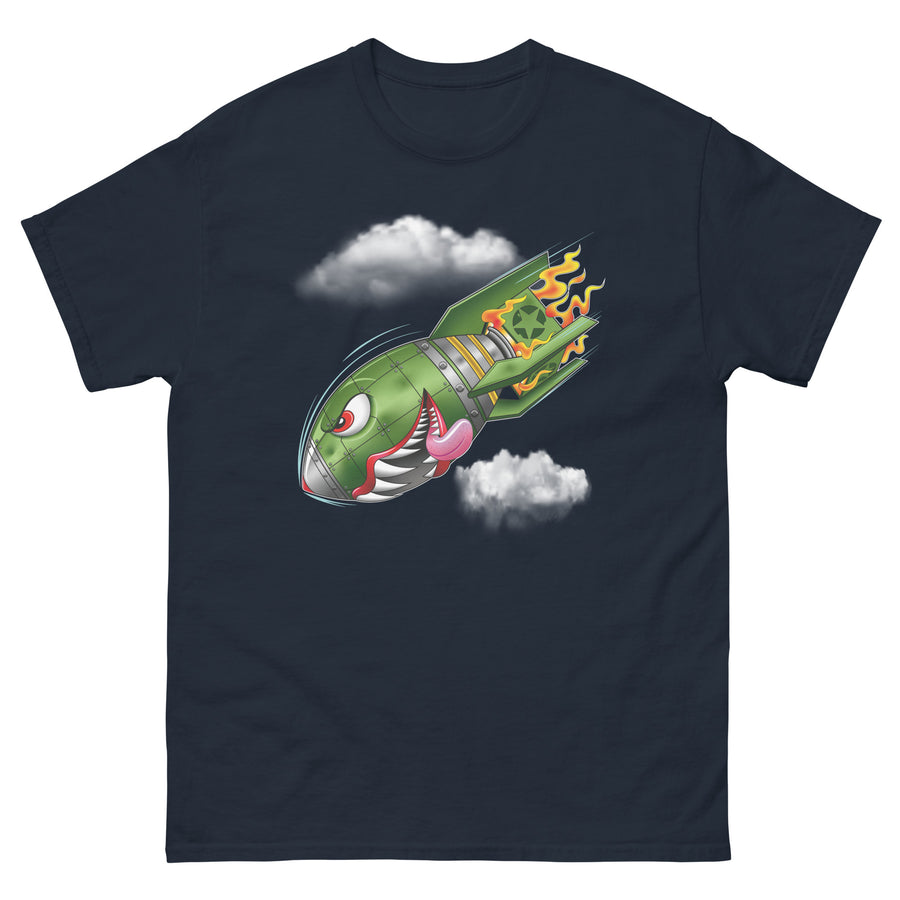 A navy blue t-shirt with a military green neo-traditional bomb tattoo design. The bomb is falling with a look of determination in its eyes, an evil toothy grin, and its tongue hanging out of its mouth. Flames are coming from the back of the bomb, and some clouds are in the background.