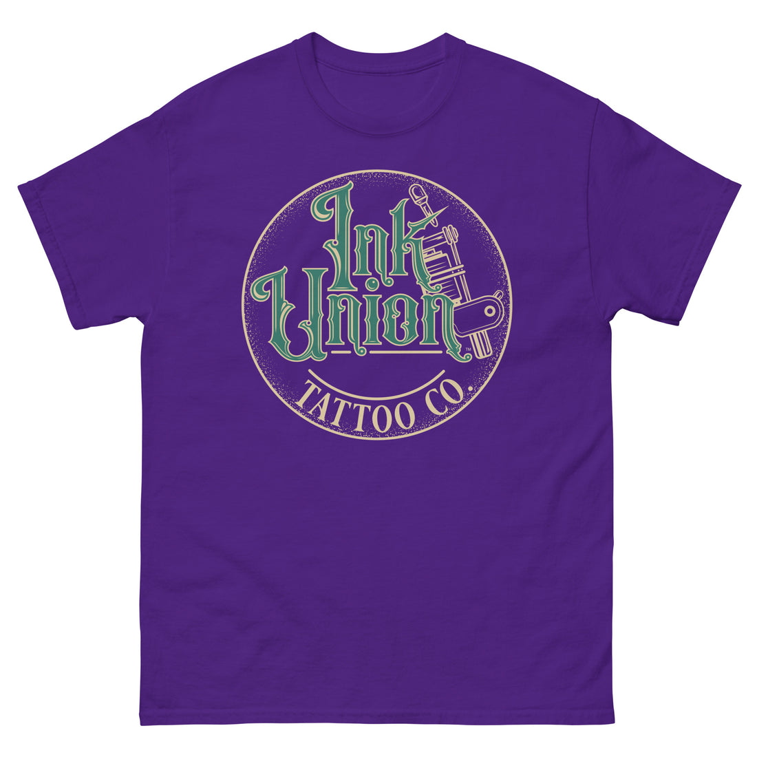 A purple t-shirt with a gold circle containing fancy lettering in green and gold that says Ink Union and a gold tattoo machine peeking out from behind on the right side.  There is a dot work gradient inside the circle, and the words Tattoo Co. in gold are at the bottom of the design.
