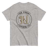 A  light grey t-shirt with the Ink Union Clothing Co Badge logo in black and gold centered on the front of the shirt.