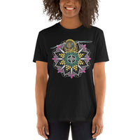 A woman wearing a black t-shirt with a mandala containing pink lotus flowers and honeycomb designs and a life-like honeybee flying toward you at the top of the mandala.