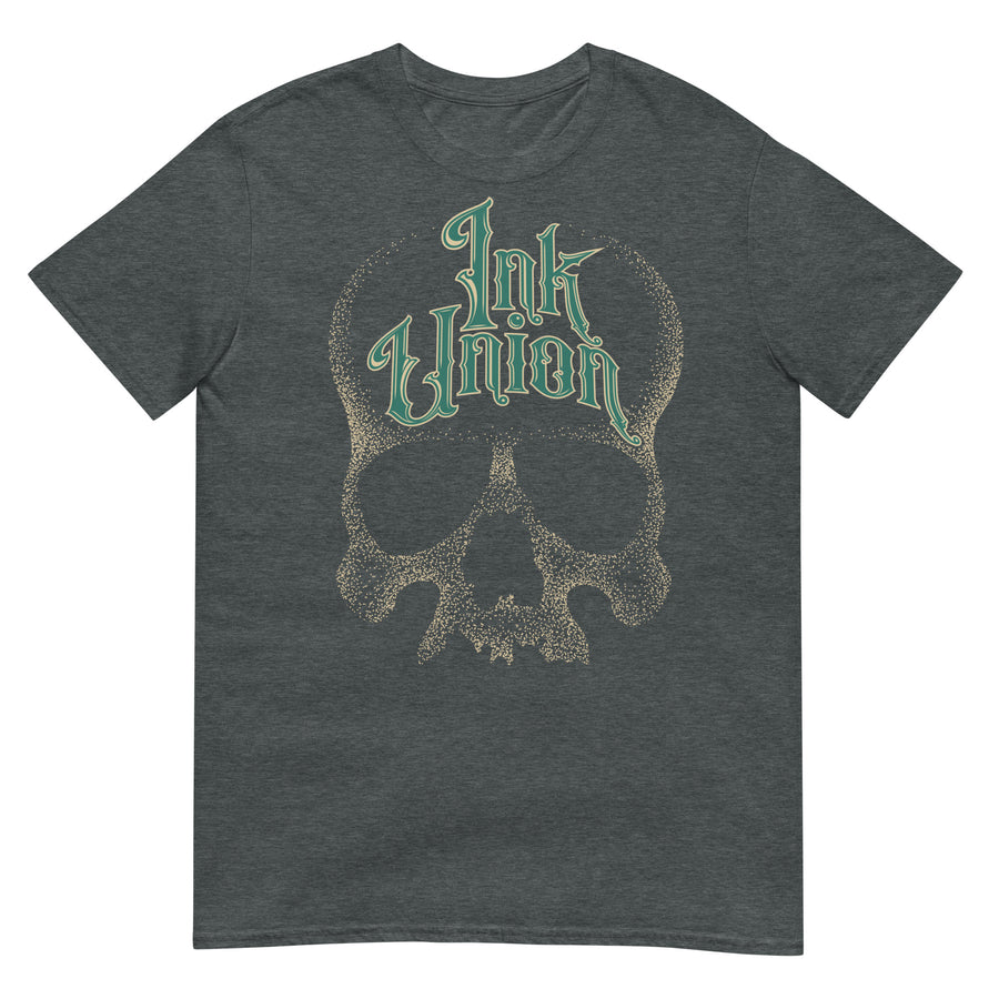 A dark grey t-shirt adorned with a gold dot work human skull  and the words Ink Union in fancy gold and green lettering across the forehead of the skull.