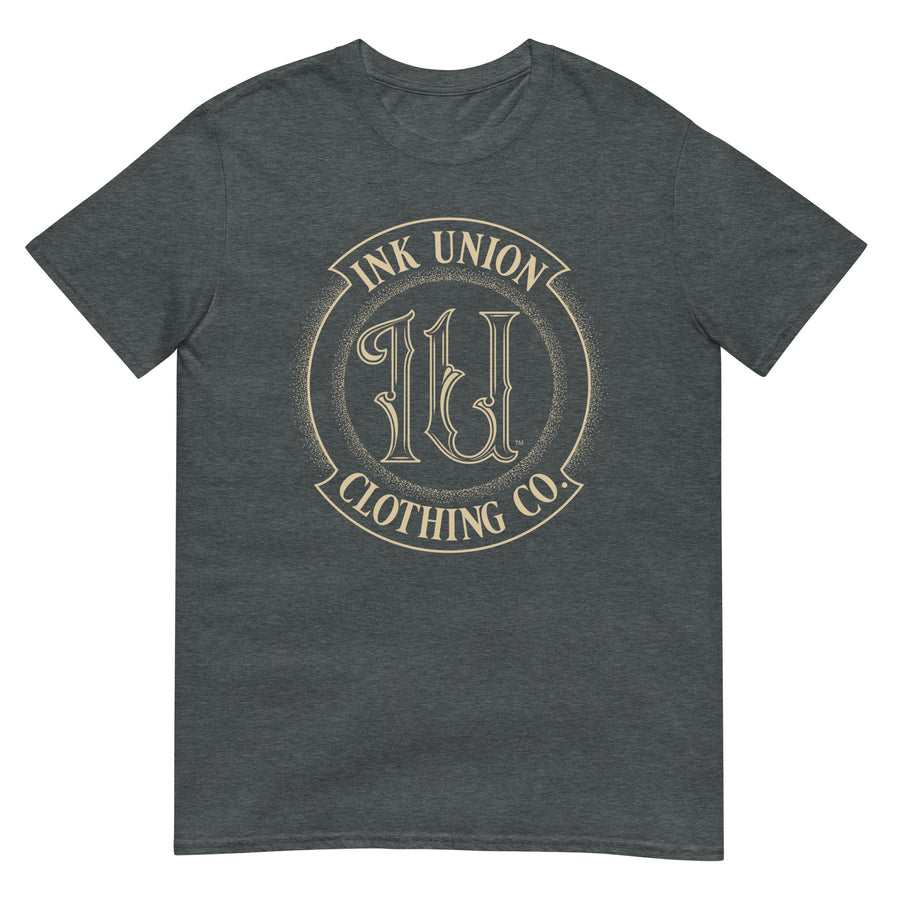 A dark grey t-shirt adorned with the Ink Union Clothing Co gold badge logo containing fancy lettering and dot work gradients.