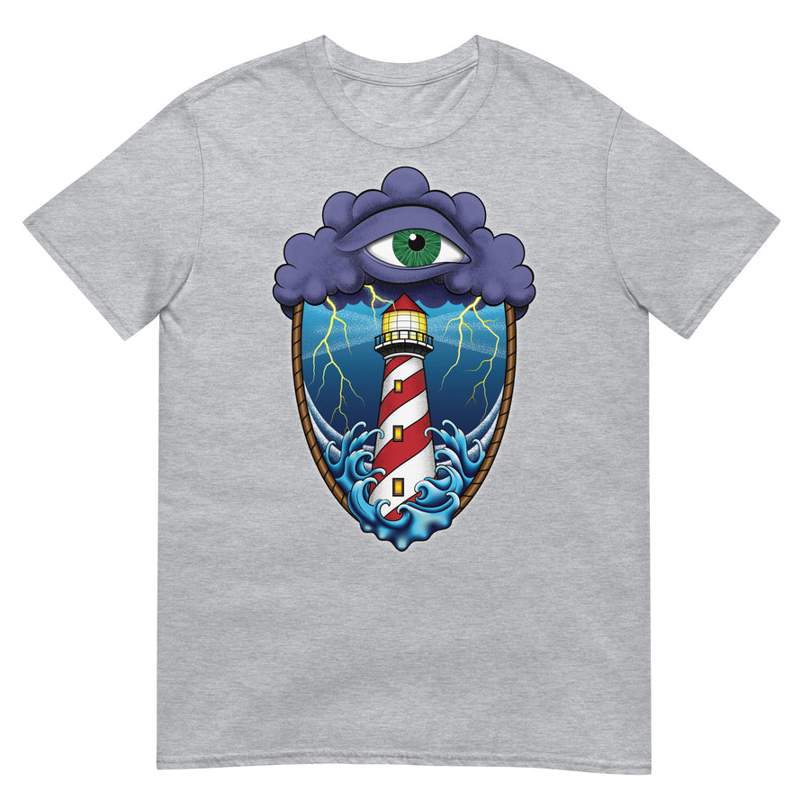 A light grey t-shirt with an old school eye of the storm tattoo design of large dark purple storm clouds at the top of the design with a green eye in the middle of the clouds.  Below the clouds is an oval shape with brown rope. Inside the rope are stormy seas and a lighthouse with lightning striking in the background.  At the bottom of the design, some of the waves are spilling out of the rope barrier. The sky and seas are hues of blue; the lighthouse is white and red striped like a barber pole.