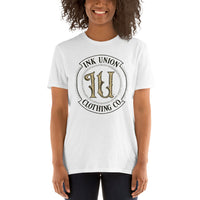 An attractive woman is wearing a white t-shirt with the Ink Union Clothing Co Badge logo in black and gold.