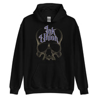 A black hoodie adorned with a gold dot work human skull and the words Ink Union in fancy gold and blue lettering across the forehead of the skull.