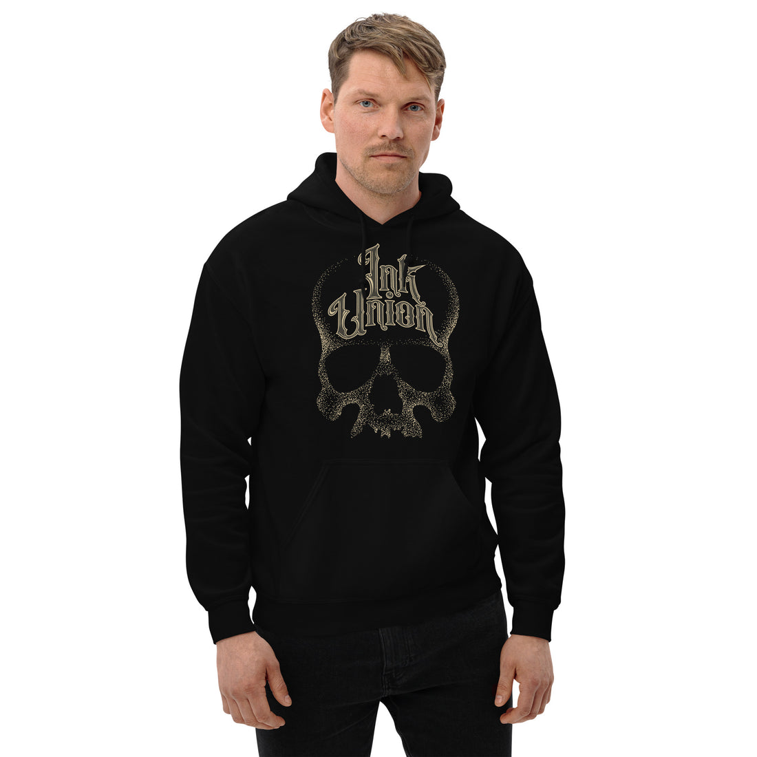 An attractive man wearing a black hoodie adorned with a gold dot work human skull and the words Ink Union in fancy gold and black lettering across the forehead of the skull.