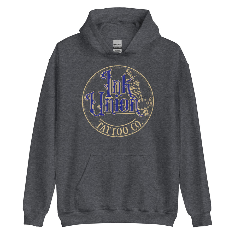 A dark grey hoodie with a gold circle containing fancy lettering in blue and gold that says Ink Union and a gold tattoo machine peeking out from behind on the right side.  There is a dot work gradient inside the circle, and the words Tattoo Co. in gold are at the bottom of the design.