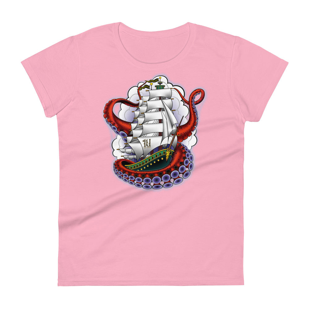 A pink t-shirt with an old-school clipper ship tattoo design in green and brown with white sails surrounded by octopus tentacles in shades of red with purple tentacles. Behind the ship are purple-tinged clouds.