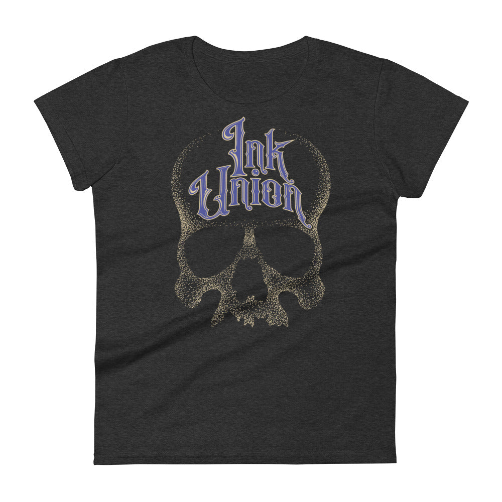 A dark grey t-shirt background with a gold dot work human skull and the words Ink Union in fancy gold and blue lettering across the forehead of the skull.