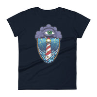 A navy blue t-shirt with an old school eye of the storm tattoo design of large dark purple storm clouds at the top of the design with a green eye in the middle of the clouds.  Below the clouds is an oval shape with brown rope. Inside the rope are stormy seas and a lighthouse with lightning striking in the background.  At the bottom of the design, some of the waves are spilling out of the rope barrier. The sky and seas are hues of blue; the lighthouse is white and red striped like a barber pole.