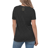 The rear view of an attractive woman wearing a black t-shirt with a small ink union logo just below the neckline.