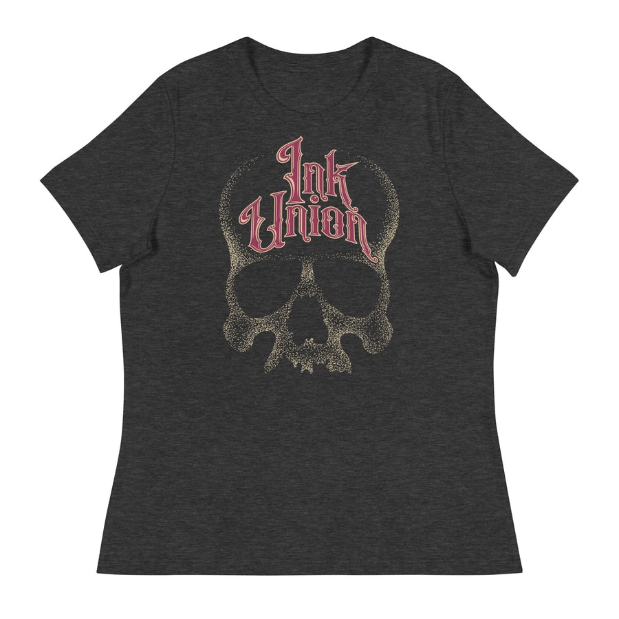 A dark grey t-shirt adorned with a gold dot work human skull  and the words Ink Union in fancy gold and red lettering across the forehead of the skull.