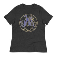 A dark grey t-shirt with a gold circle containing fancy lettering in blue and gold that says Ink Union and a gold tattoo machine peeking out from behind on the right side. There is a dot work gradient inside the circle, and the words Tattoo Co. in gold are at the bottom of the design.