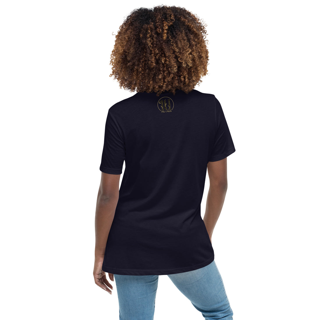 The back of an attractive woman wearing a navy blue t-shirt with a small gold and black Ink Union ring Logo centered just under the neckline.