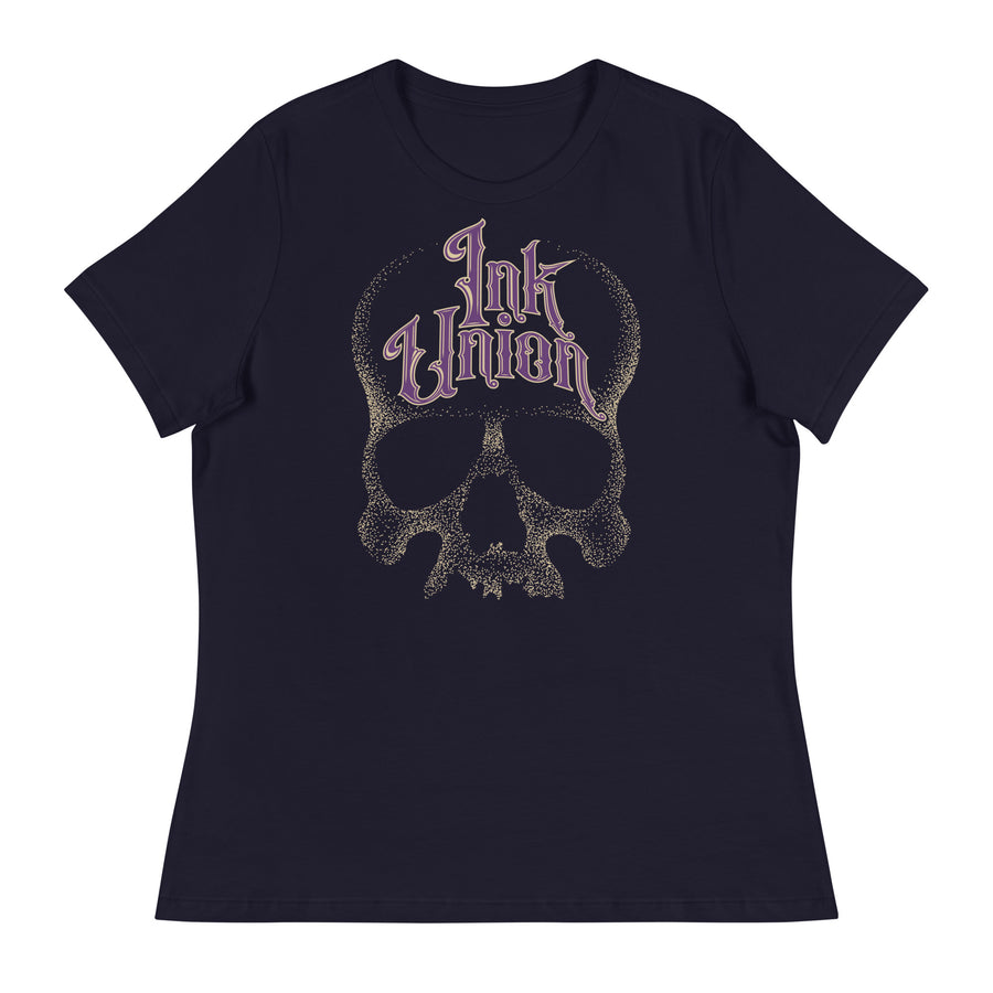 A navy blue t-shirt adorned with a gold dot work human skull  and the words Ink Union in fancy gold and purple lettering across the forehead of the skull.