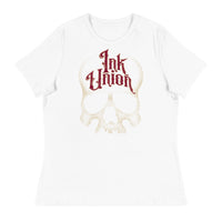 A white t-shirt adorned with a gold dot work human skull  and the words Ink Union in fancy gold and red lettering across the forehead of the skull.