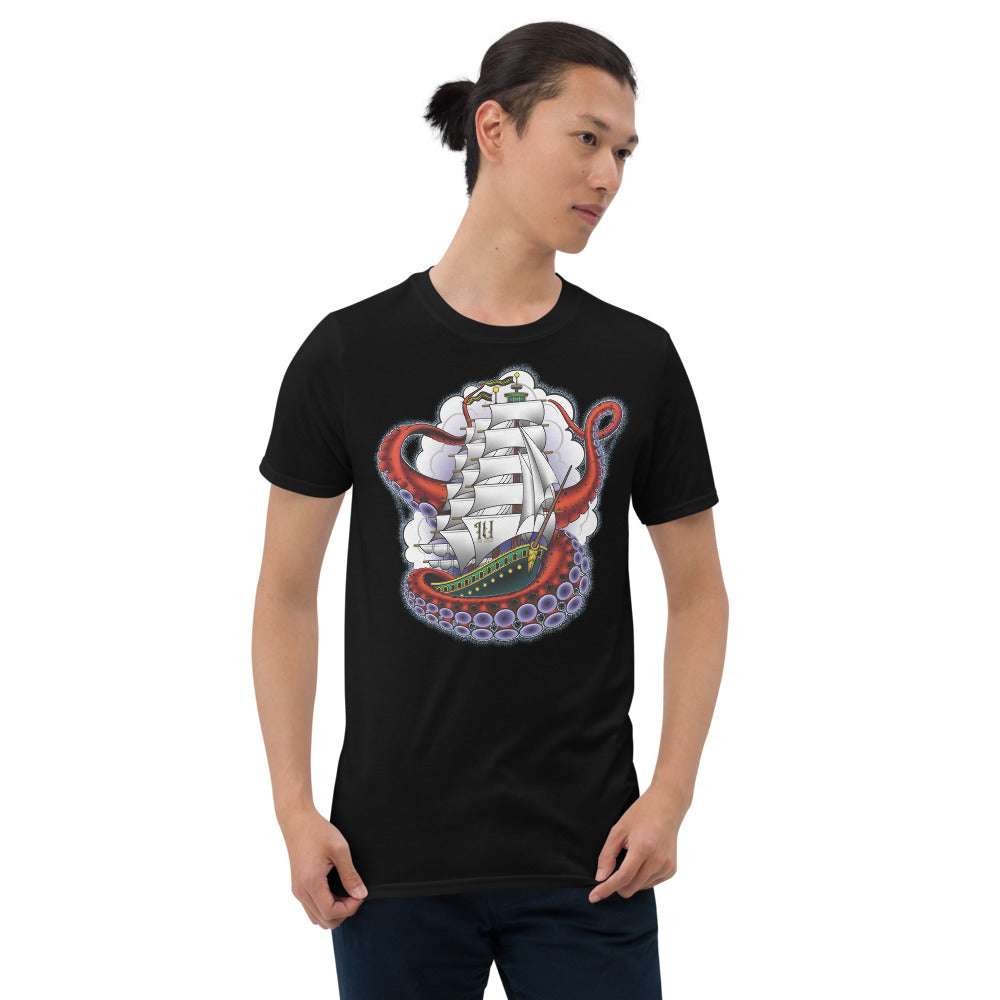 man wearing an Ink Union Clothing Co. unisex black t-shirt featuring a clipper ship surrounded by octopus tentacles with storm clouds in the background