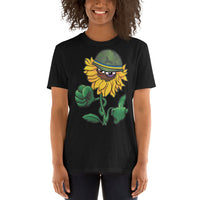 woman wearing an Ink Union Clothing Co. black unisex t-shirt with a  Sunflower with a scowling face and army helmet with the Ukrainian flag colors on the band.  The leaves on one side are curled into a fist the leaves on the other side are flipping the bird