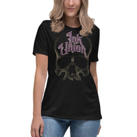woman wearing an Ink Union Clothing Co. women's relaxed fit black t-shirt  featuring a large dot work gold skull centered on the shirt and Ink Union in large fancy gold and purple script across the forehead of the skull